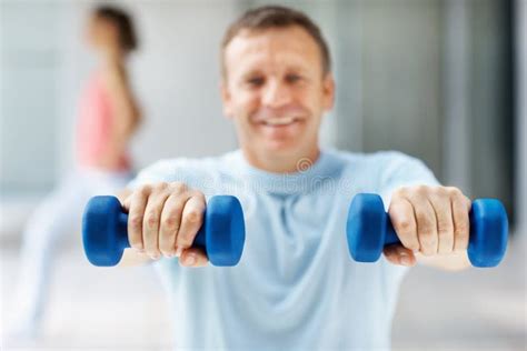 Guy Working Out With Dumbbells While At The Gym Stock Photo Image Of
