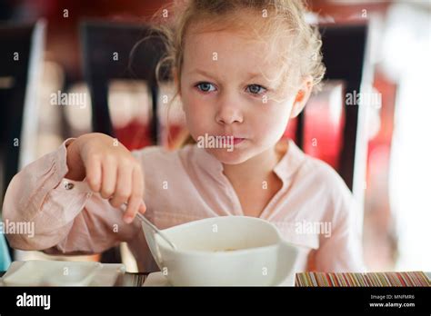 Adorable Little Girl Eating Breakfast In Restaurant Stock Photo Alamy
