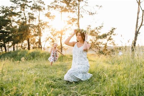 Stylish Mother And Handsome Daughter Having Fun On The Nature Happy Family Concept Stock Photo