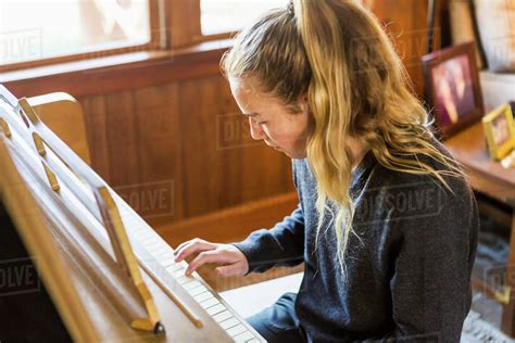 Teenage Girl Playing Piano Practising Stock Photo Dissolve