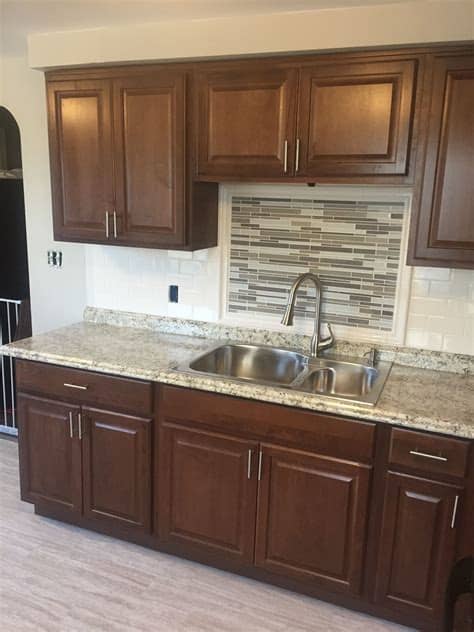 Cognac has copper tones and is stylishly flexible, enhancing the fine grain of maple with an elegant. Hampton Bay cognac kitchen cabinets with subway tile ...