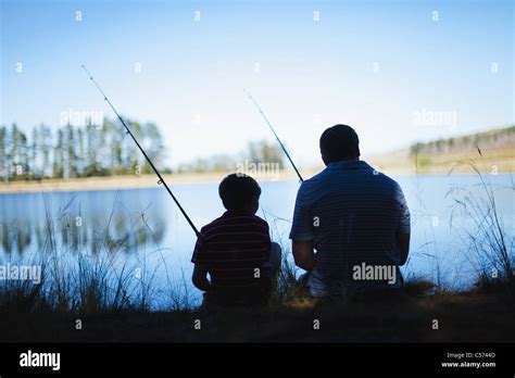 Father Fishing With Son In Lake Stock Photo Royalty Free Image