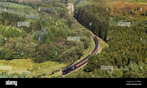 Steam Train Navigating A Valley On The North Yorkshire Railway Seen In