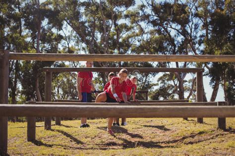 Trainer Instructing Kids During Obstacle Course Training Stock Image