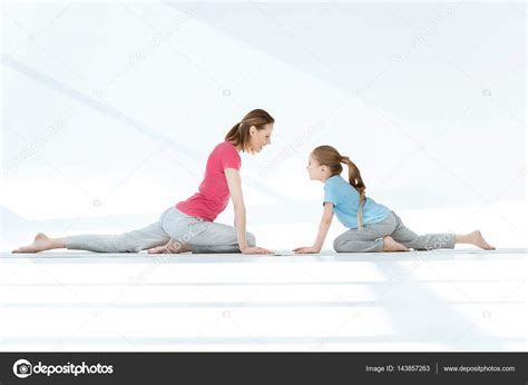 Mother And Daughter Exercising Stock Photo By ©igortishenko 143857263