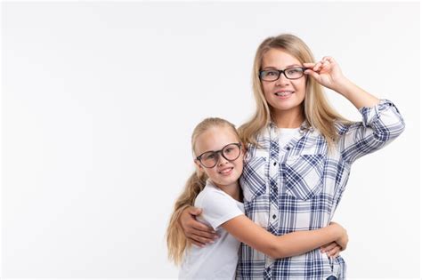 Premium Photo Portrait Of Mother And Daughter With Eyeglasses On White Wall