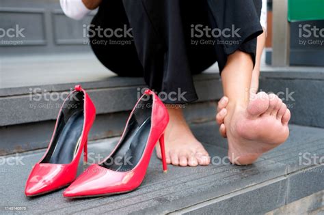Women With Leg Cramps And Ankles From High Heels She Sat On The Stairs