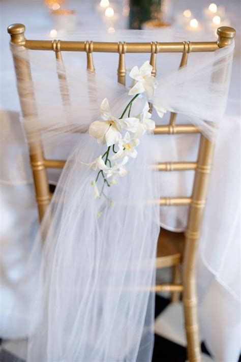 Chair Backs Of Brides Attendants Tied With Tulle And Her Choice Of
