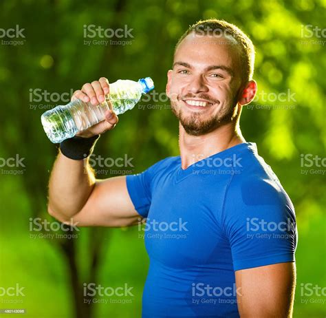 Athletic Mature Man Drinking Water From A Bottle Stock Photo Download