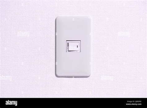 Simple Light Switch In Room Which Is Installed On The White Coloured