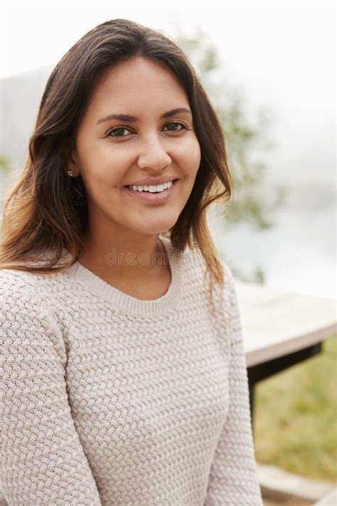 Young Mixed Race Woman Smiling To Camera In A Park Vertical Stock