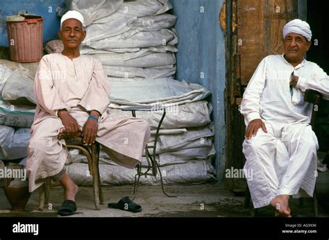 shopkeepers wearing traditional jellabiya or galabeya clothing in khan el khalili a major souk