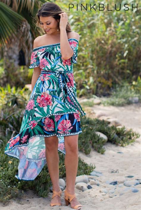 An Off Shoulder Tropical Floral Print Dress Featuring A Hi Low Ruffle