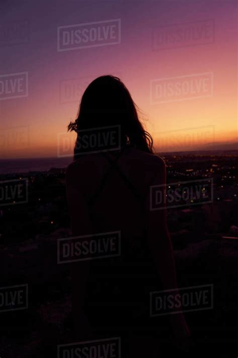 Back View Of Relaxed Woman With Naked Shoulders Standing And Contemplating Majestic Sunset In