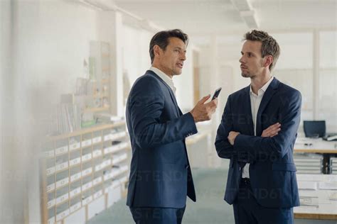 Businessmen Talking In Office Stock Photo