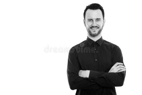 Studio Shot Of Happy Young Man Smiling With Arms Crossed Stock Photo