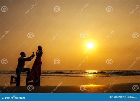 Romantic Marriage Proposal At The Seaside At Sunset On The Beach Sea