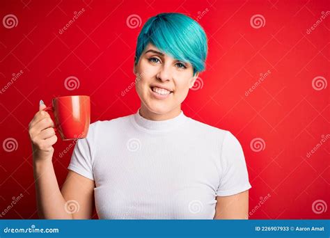 Young Woman With Blue Fashion Hair Drinking A Cup Of Coffee S Over Red