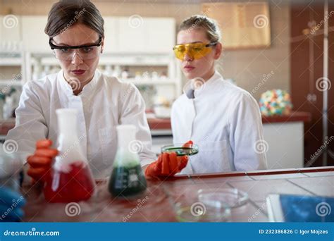 Young Female Chemistry Students In The University Laboratory Observe A