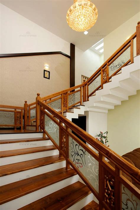 The Stairs Are Made Of Wood And Have Decorative Glass Railings On Each