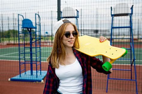 A Pretty Blond Girl Wearing Checkered Shirt White Cap And Sunglasses