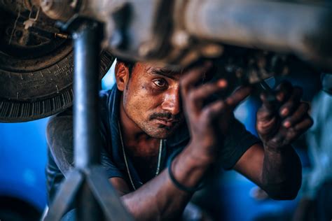 Wallpaper Id 256634 A Car Mechanic Working On An Old Car In A