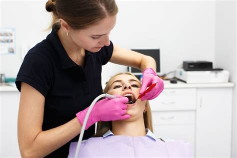 Free Photo Female Dentist Treating Her Patient Teeth