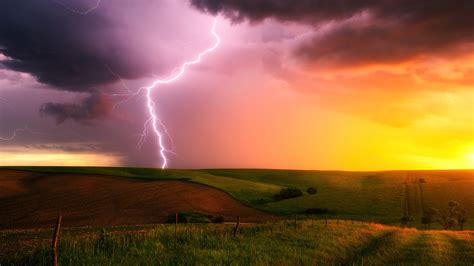 2048x1152 Thunderstorm Lightning Bolt Striking Down At Sunset In
