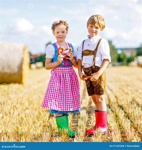 Two Kids In Traditional Bavarian Costumes In Wheat Field German