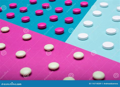 assortment of various colourful pills on pastel coloured background medication and prescription