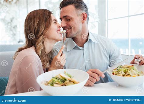 Photo Of Happy Romantic Couple Having Dinner And Eating Salats T Stock