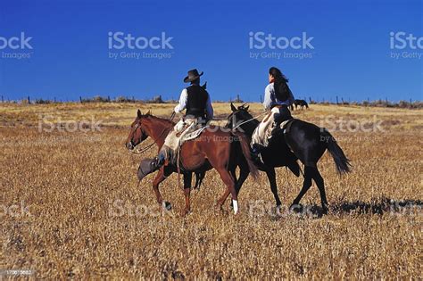 Cowboy And Cowgirl Riding Together Ranch Wild West Couple Copyspace