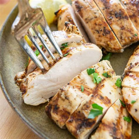 grilled chicken breast cooked on a gas grill fifteen spatulas