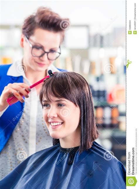 Hairdresser Cutting Woman Hair In Shop Stock Photo Image