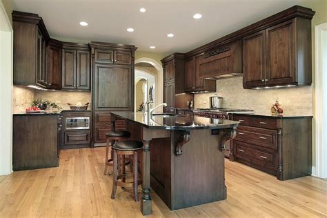 Dark cabinets and flooring truly complement the complexity of the marble color palette. 43 "New and Spacious" Darker Wood Kitchen Designs & Layouts