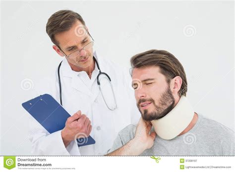Male Doctor Examining A Patients Sprained Neck Stock Image Image Of
