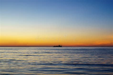 Ship Silhouette Far Away At The Sea During Sunset Stock Photo Image