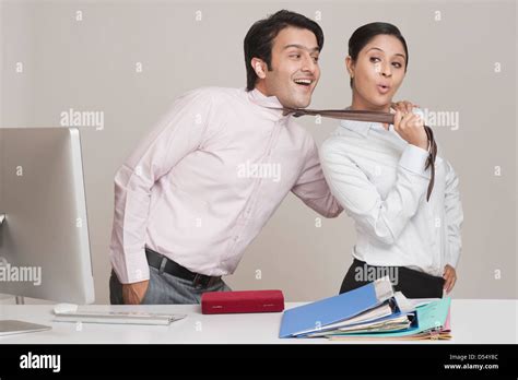 Businesswoman Flirting With A Businessman In An Office Stock Photo Alamy