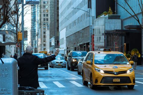 Man In Black Jacket Waiting For A Taxi Cab · Free Stock Photo