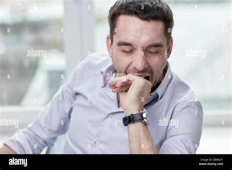 Yawning Tired Man At Home Or Office Stock Photo Alamy