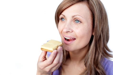 Premium Photo Attractive Woman Eating A Cracker With Cheese