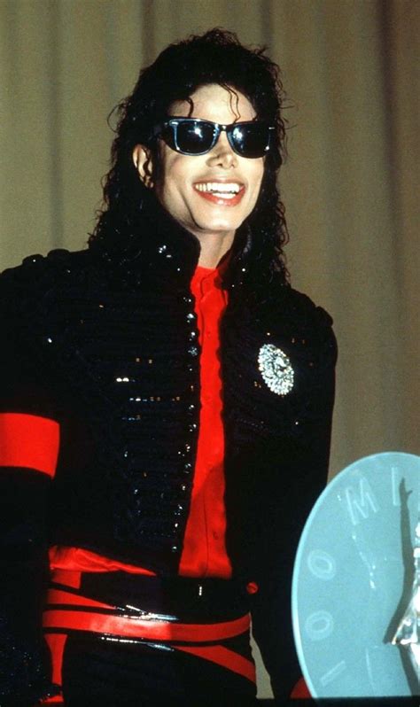 Michael Jackson Dressed In Black With Red Tie And Sunglasses