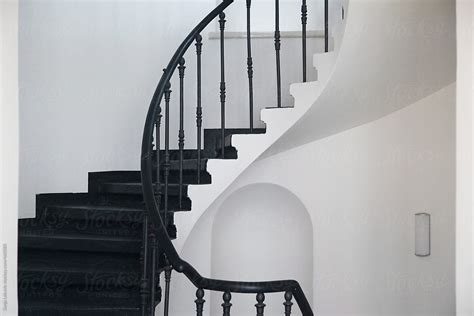 Black Spiral Staircase In White Building By Stocksy Contributor