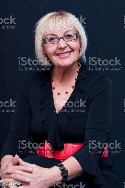 Portrait Of Sitting Smiling Attractive Blonde Mature Woman With