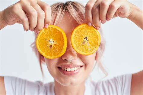 Smiling Woman Holding Oranges At Her Face Like Eyes Stock Photo Image