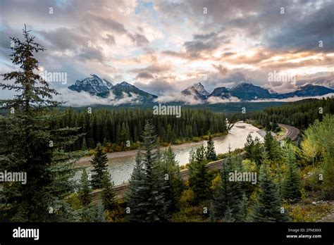 Cloudy Rocky Mountains At Sunset Morants Curve Forested Shore At Bow