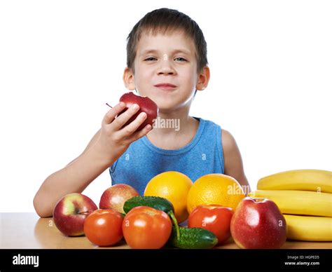 Happy Healthy Boy Eating Apple With Fruits And Vegetables Isolated