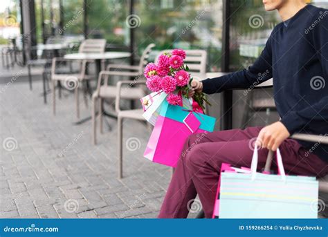 Boyfriend Waiting For His Girlfriend Near Cafe And Holding Flowers