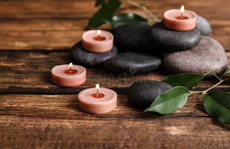 composition of spa stones green leaves and burning candles stock image image of beautiful