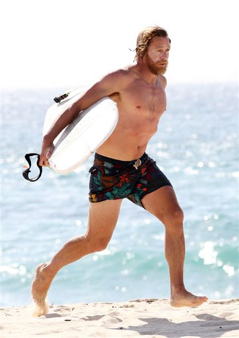 Shirtless Simon Baker Sports Scruffy Beard On Surfing Excursion